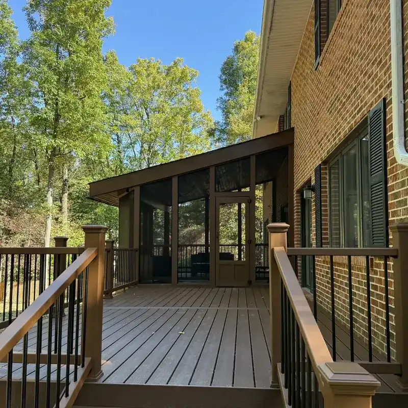 Composite deck with screened porch and brick home