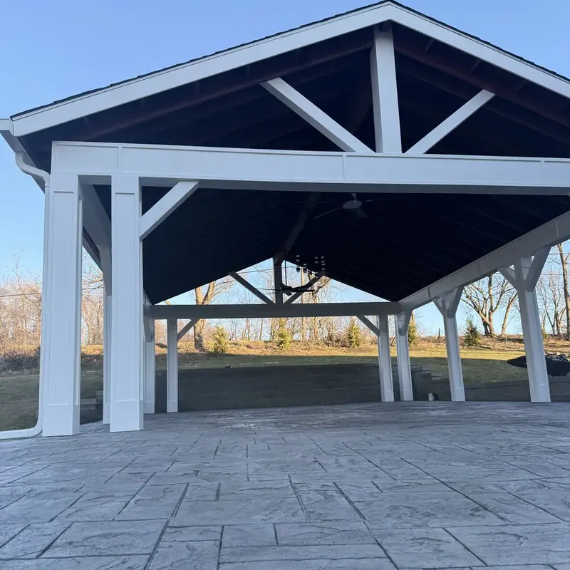 Underside view of outdoor pavilion with chandelier and trusses
