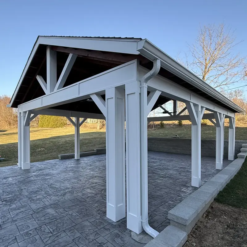 White pavilion with timber framed roof over patio