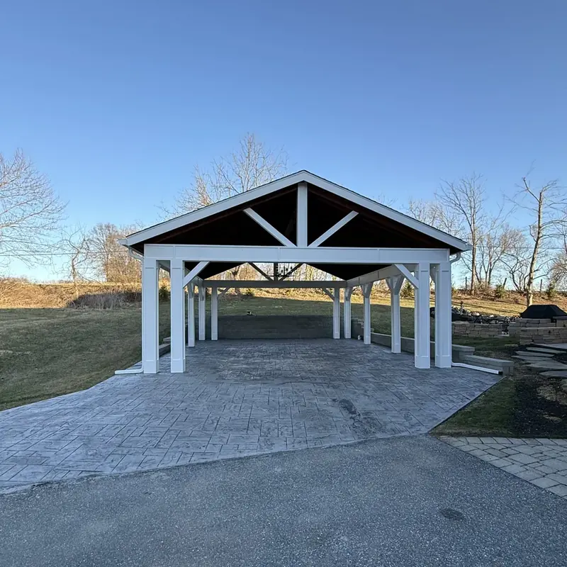 Front view of white pavilion over stamped concrete patio