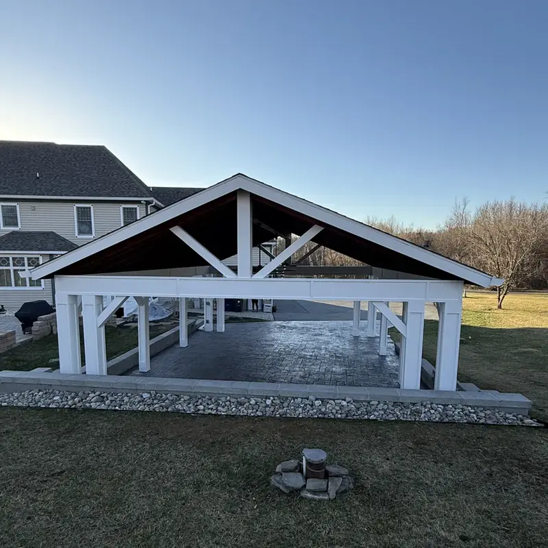 Pavilion next to home with fire pit foreground