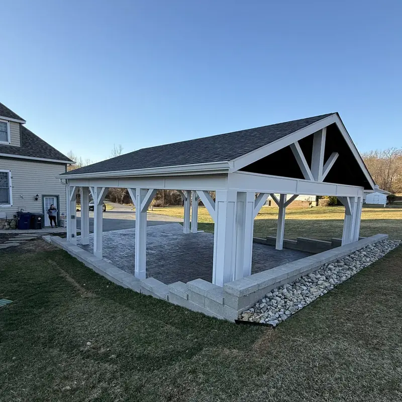 Pavilion next to two-story home with stone foundation