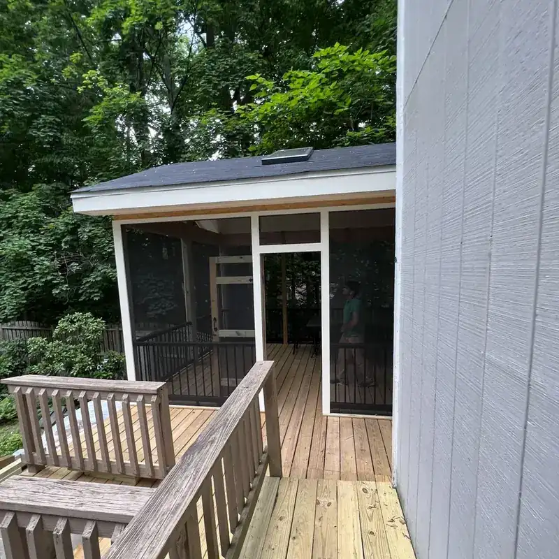 Wood deck with screened porch addition and railing