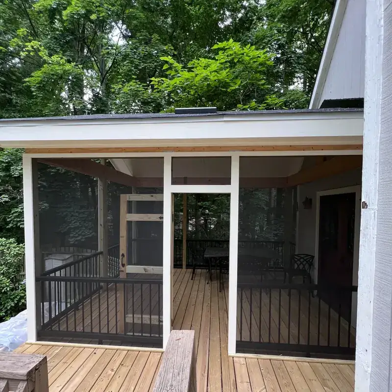 Screened porch with wood deck and metal railings
