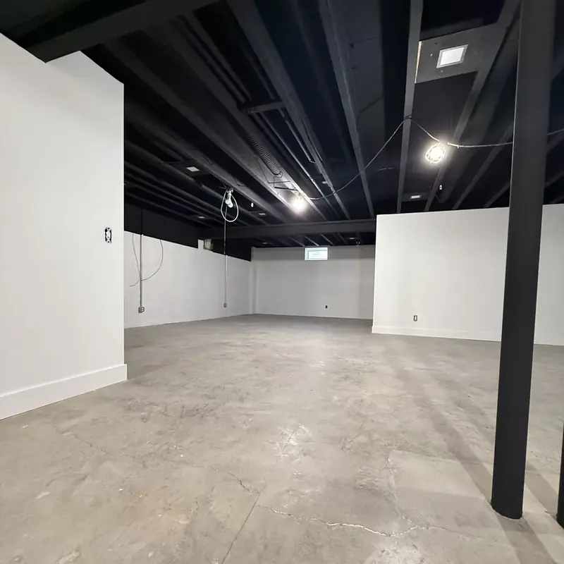unfinished basement with black ceiling and concrete floor