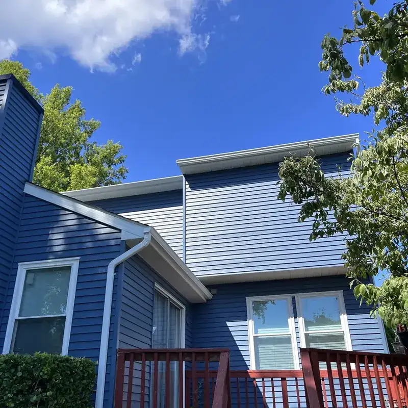 rear addition with blue siding and white trim