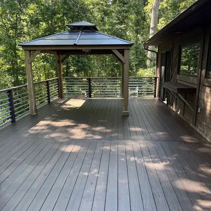 composite deck with gazebo and cable railing in woods