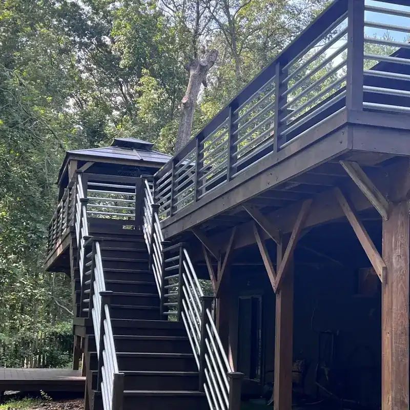 Elevated dark wood deck with stairs and posts
