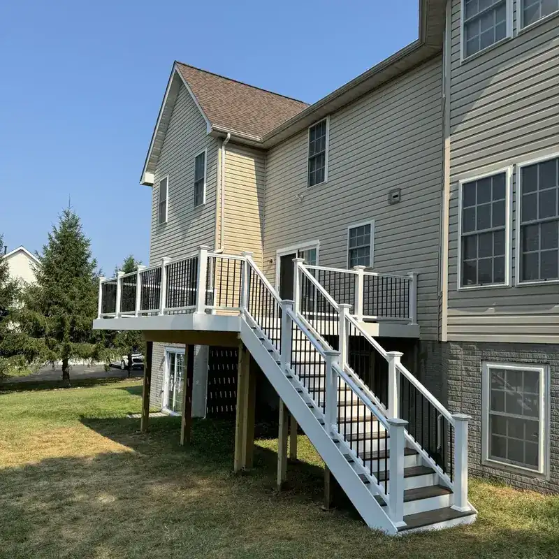 Two-tone elevated deck with white railings and stairs