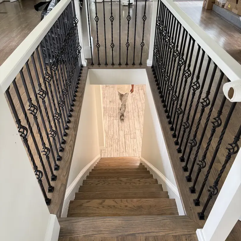 Hardwood staircase with wrought iron balusters down view