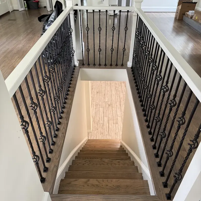 Hardwood staircase with wrought iron balusters down view