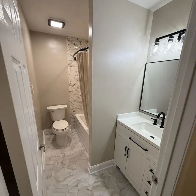 Bathroom with toilet, vanity, marble shower curtain area