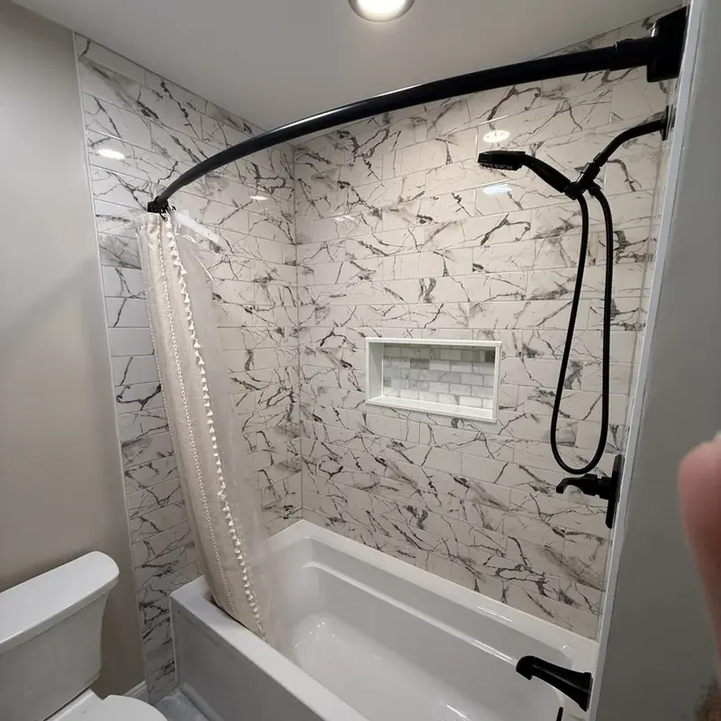 Marble shower tub with curtain, niche, black fixtures