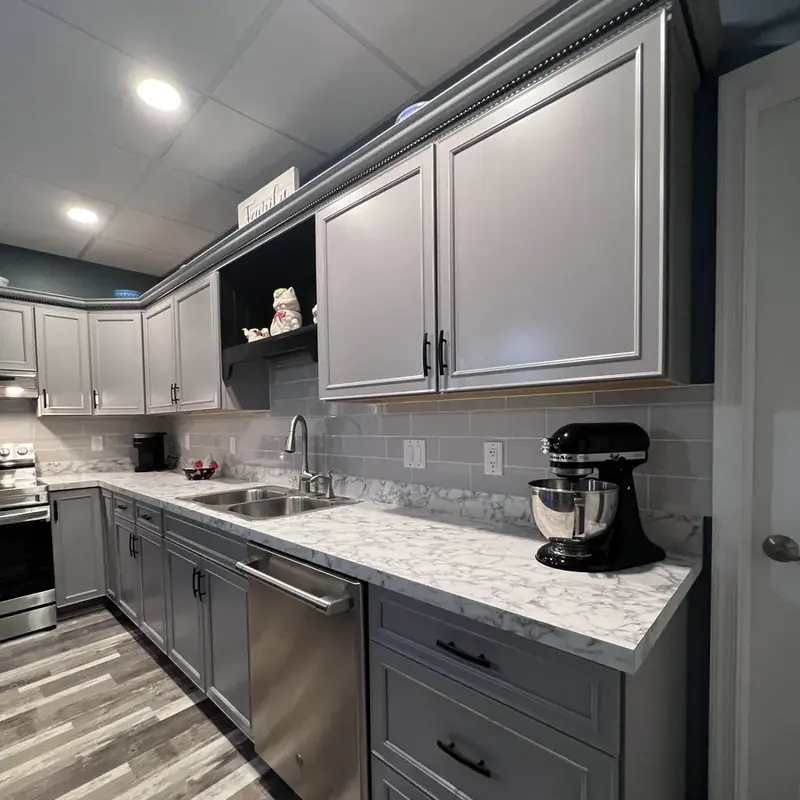 Basement kitchen counter with stand mixer and gray cabinets