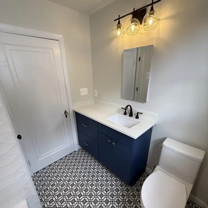 navy vanity white counter patterned tile floor