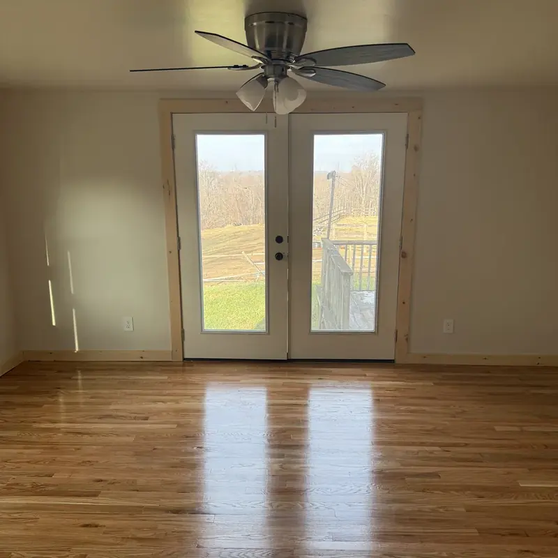 empty room with hardwood floor and french doors