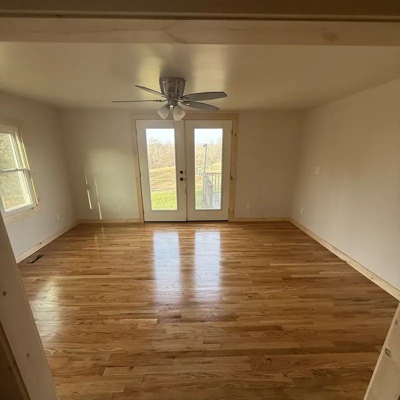 empty room with ceiling fan and french doors