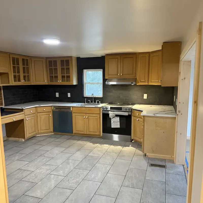 oak cabinet kitchen with tile floor and appliances