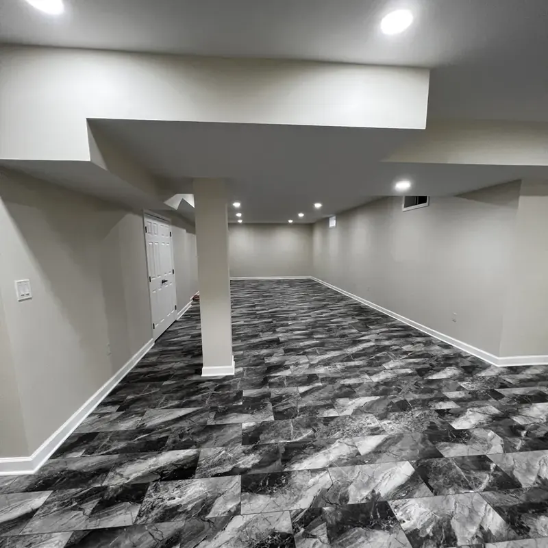 finished basement with column and patterned floor