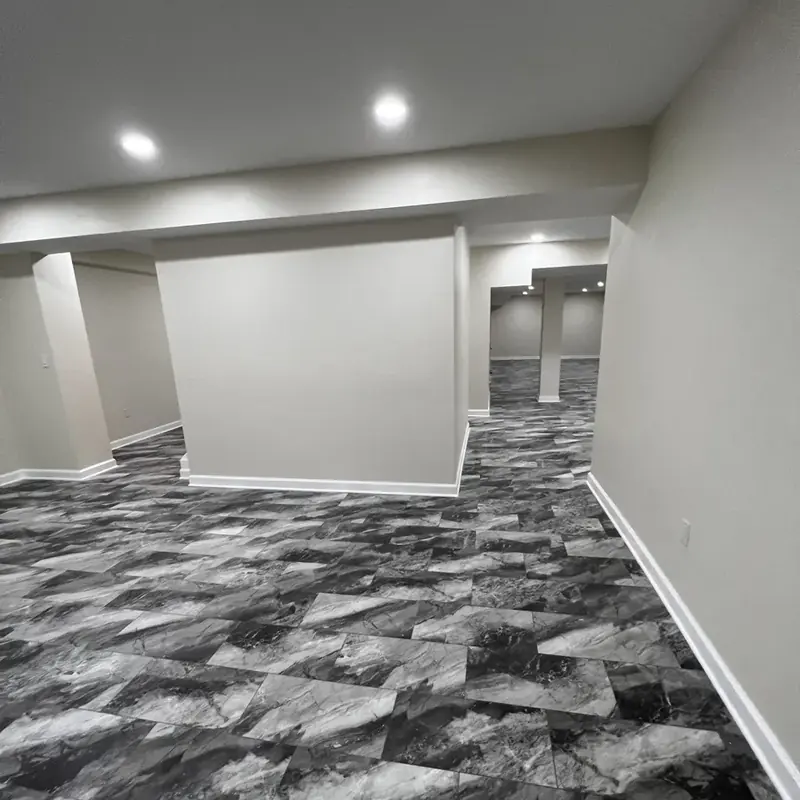 finished basement with column and tiled floor