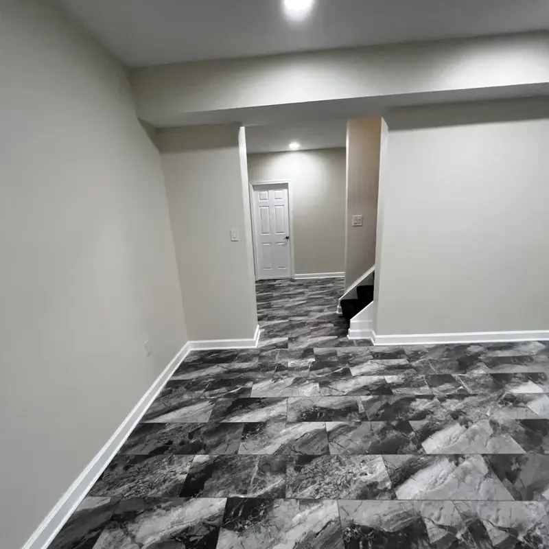 finished basement with stairs and tiled flooring