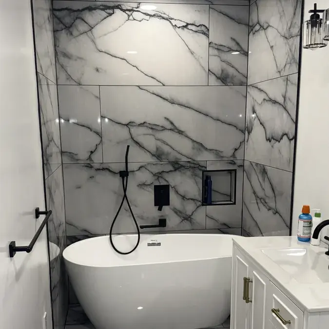 Soaking tub against marble tile wall with vanity