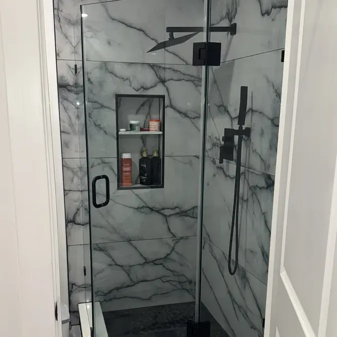 Glass marble shower enclosure with niche shelves