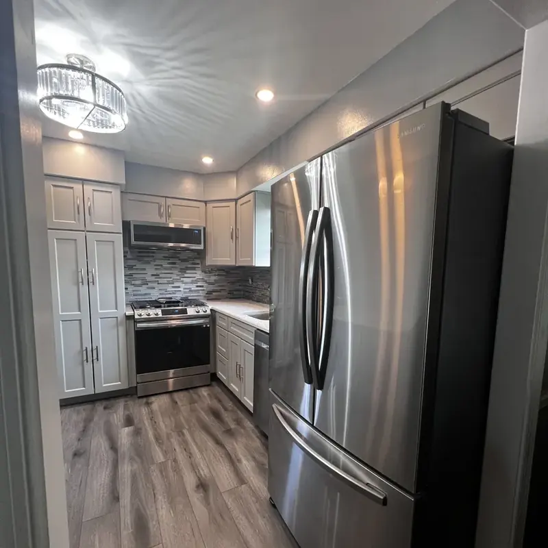 Gray cabinet kitchen with stainless steel refrigerator
