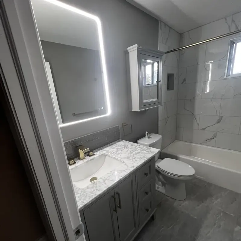 Bathroom with gray vanity LED mirror tub and tile