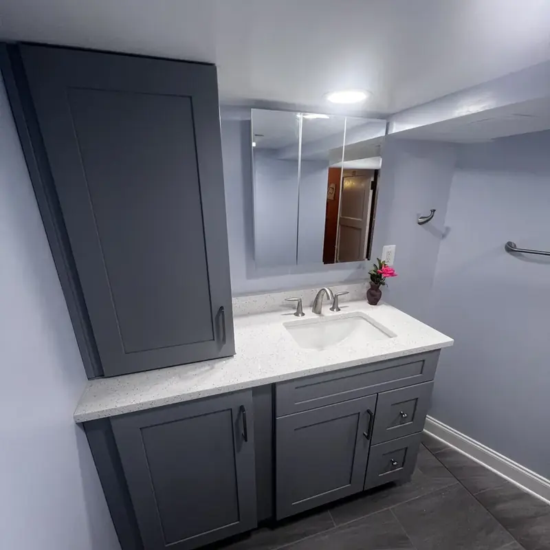 Gray bathroom vanity with mirror and tall cabinet