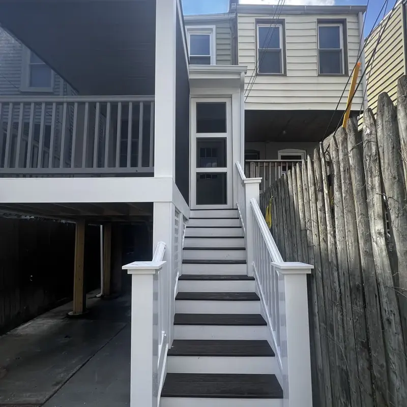White exterior staircase leading to deck