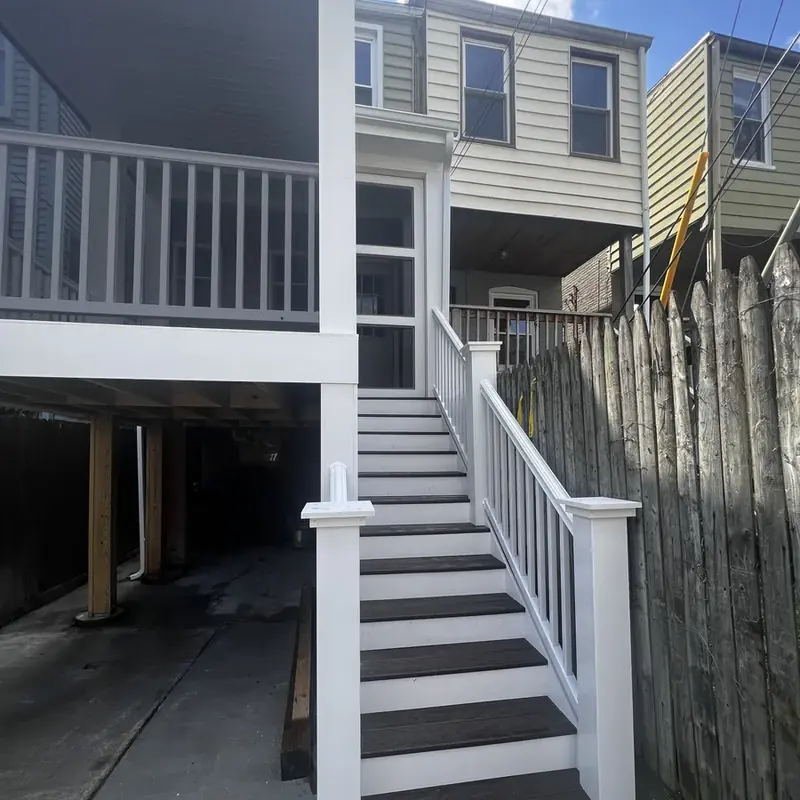 Exterior wooden stairs to deck with railings
