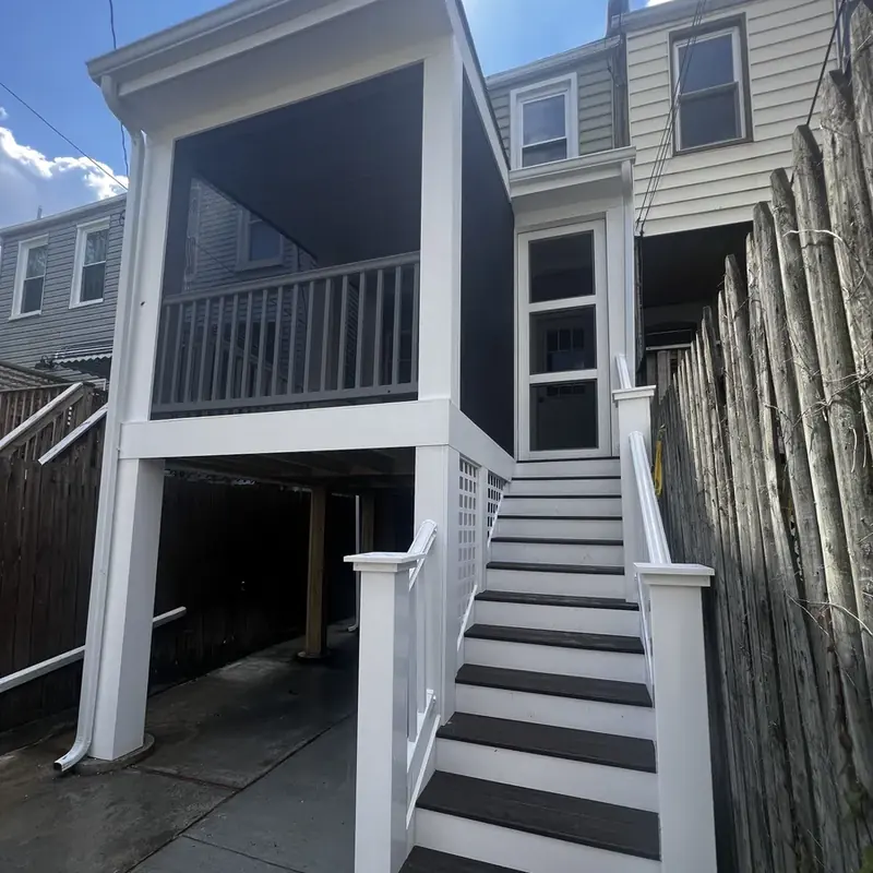 Raised deck and stair structure between row houses