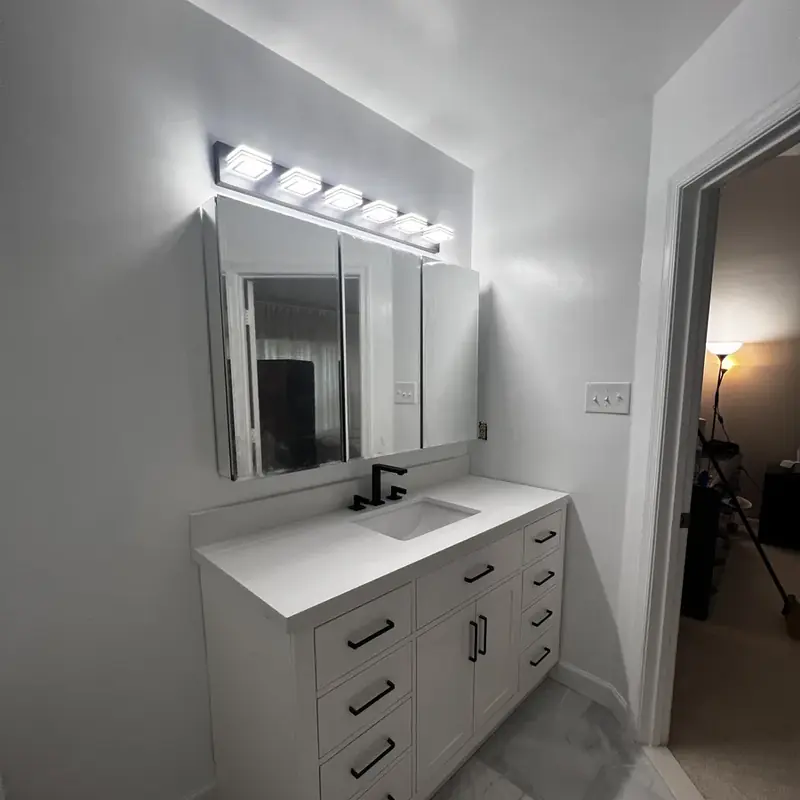 White vanity with mirror and Hollywood lights