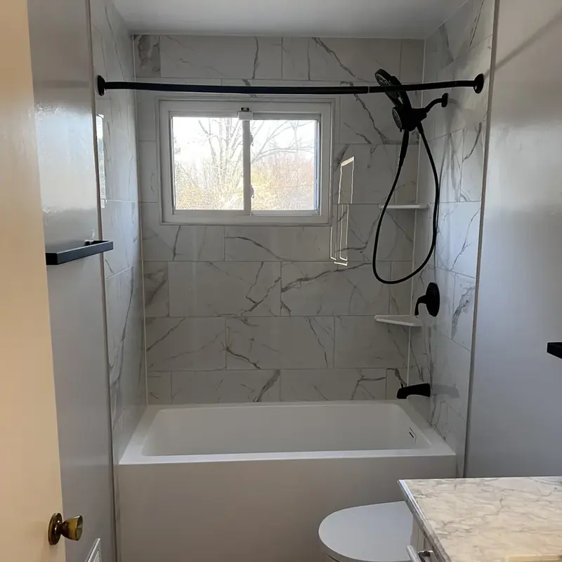 Marble tub-shower with window and black fixtures
