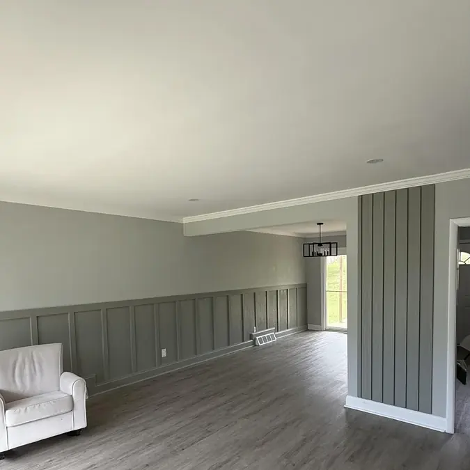 Open-concept living and dining remodel with board-and-batten wainscoting and luxury vinyl flooring